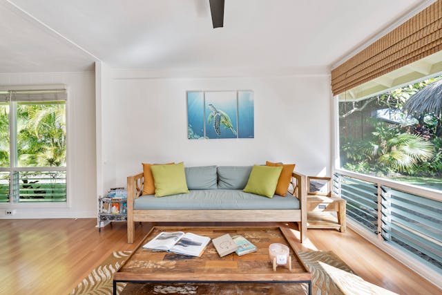 airy living room with a photo of an underwater turtle hanging above a colorful couch
